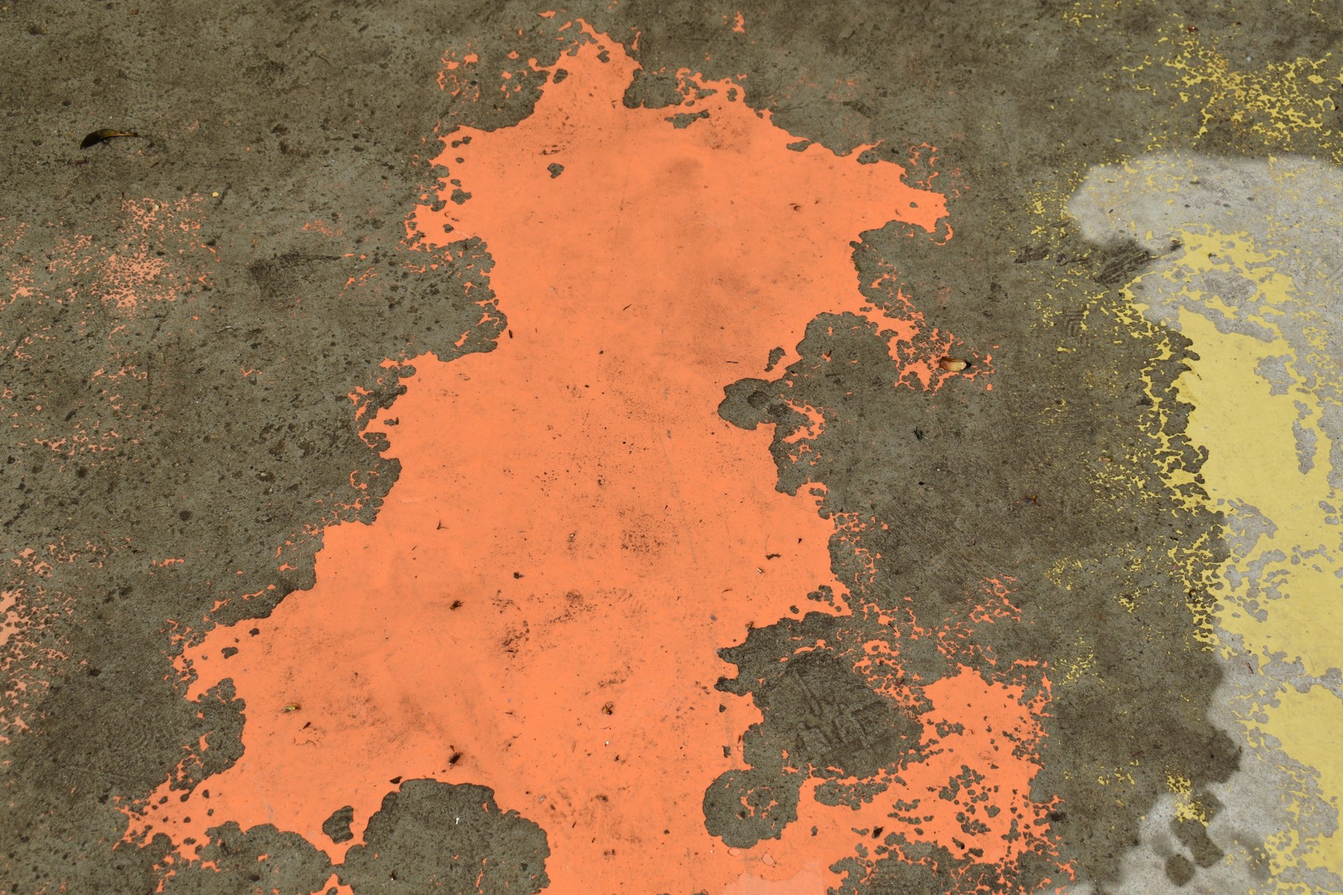 a grungy surface with orange paint on it